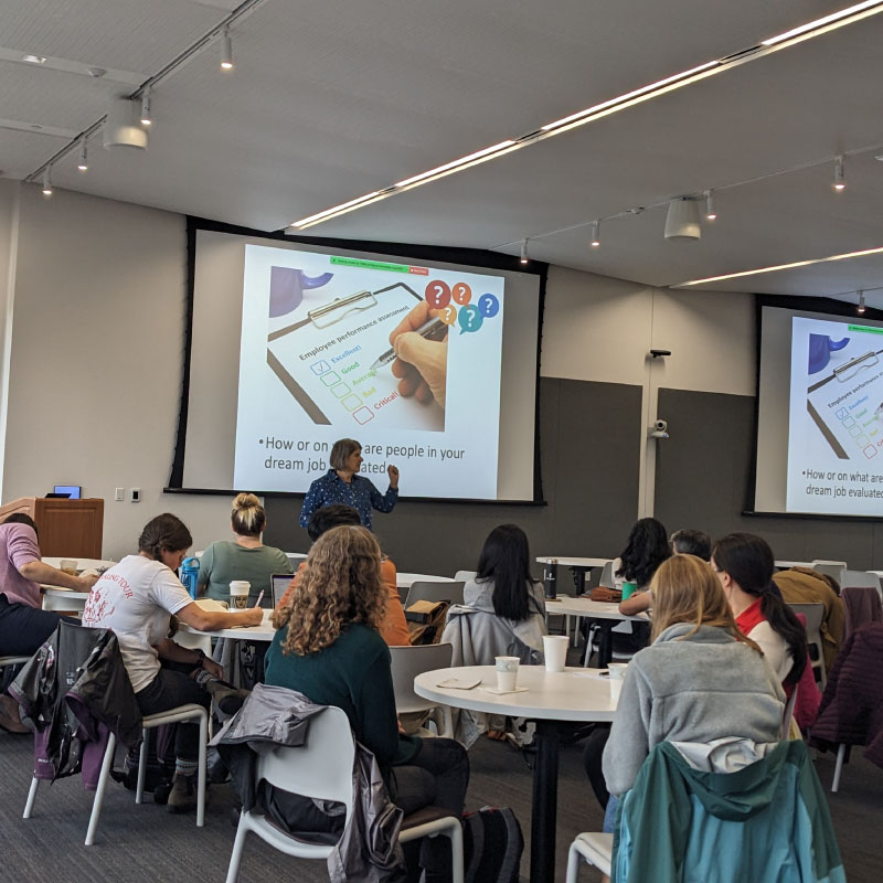 Postdocs watch a presentation in a classroom